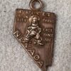 Vintage Nevada copper charm